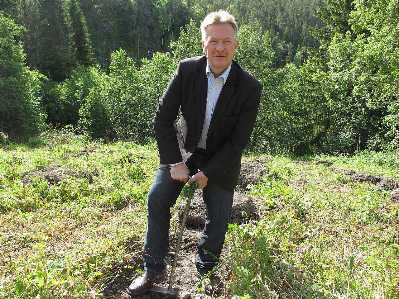 man planting hazelnut sapling