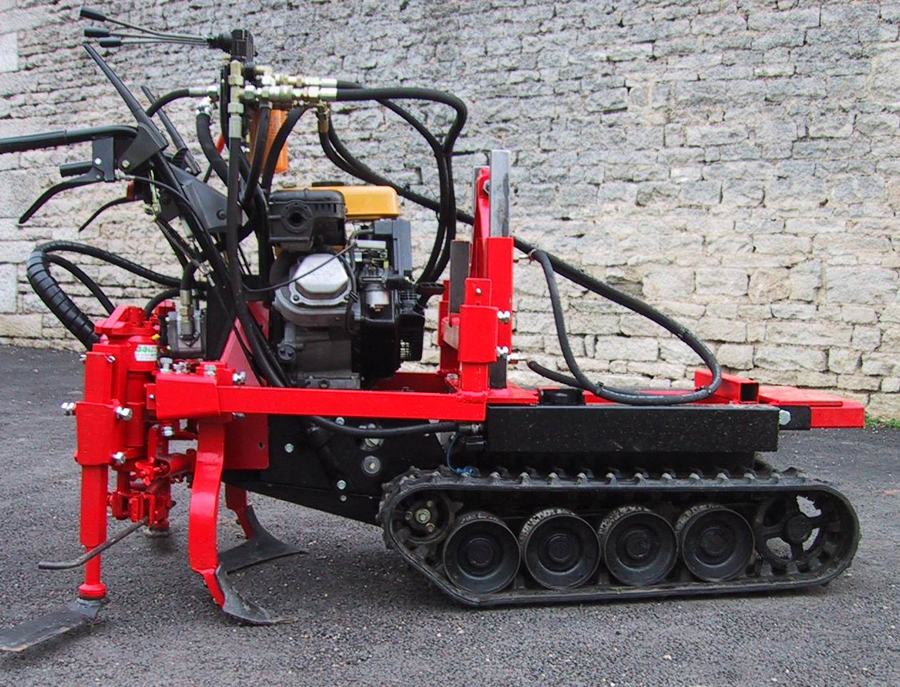 red tracked soil preparation machine