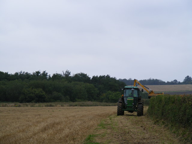 tractor in field with machinery